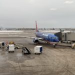 Sun Country Airlines Review. Plane waiting at gate for passengers to board.