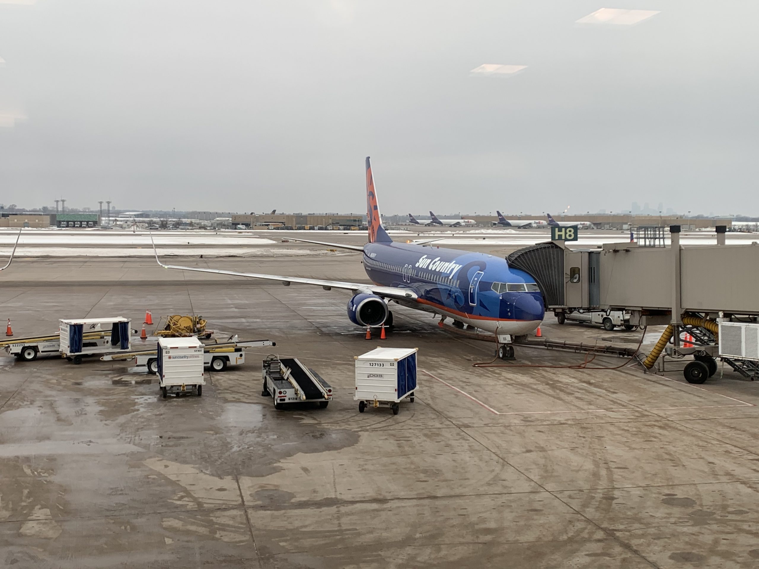 Sun Country Airlines Review. Plane waiting at gate for passengers to board.