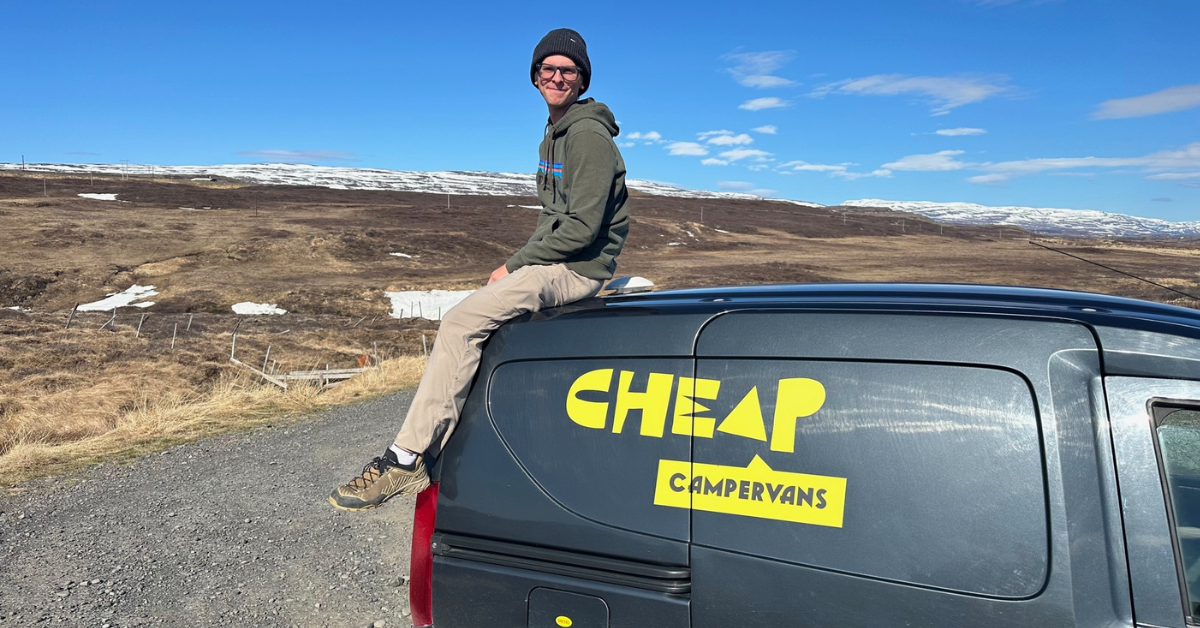 Sitting on top of campervan in iceland while camping