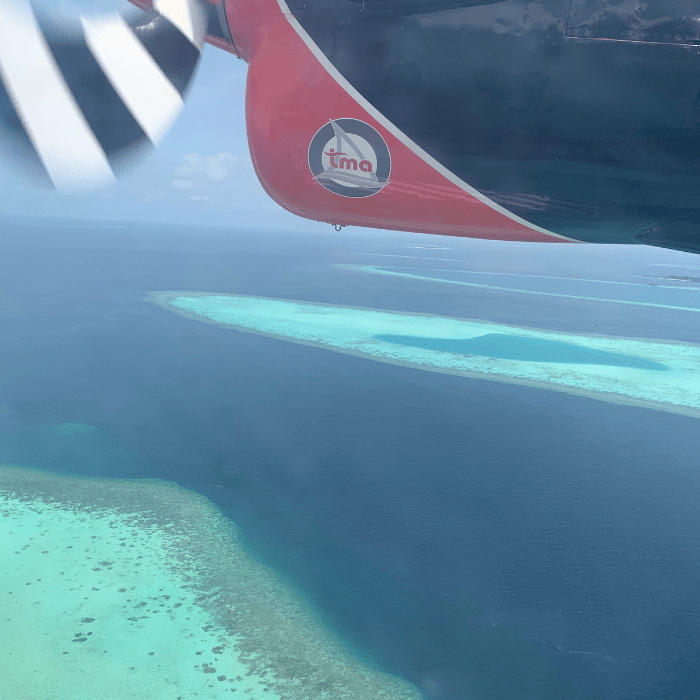 Sea Plane in the maldives with ocean water below