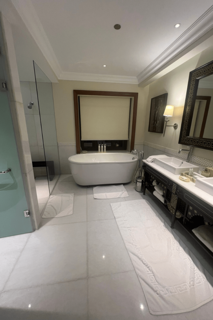 bathroom with white floor and deep soaking tub