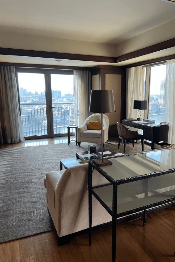 iving area with floor-to-ceiling windows overlooking the Nile at St. Regis Cairo